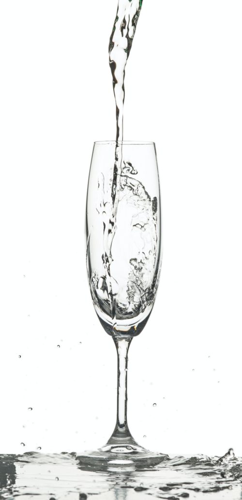 The water splashing to glass on white background